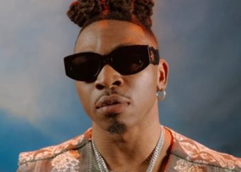 Day singer Mayokun tries breaking an old TV set (Watch Video)